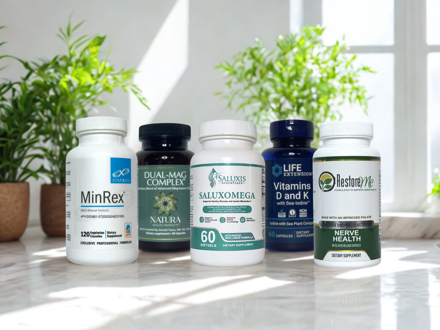 Saluxis Essentials Bundle supplement bottles on a surface with plants in the background